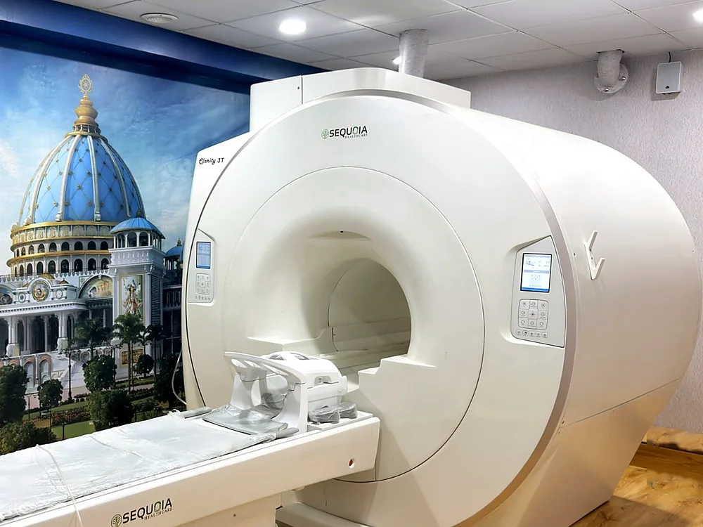 The MRI suite at Veda Diagnostic Centre, with the Sequoia Clarity 3T scanner beside a painted temple mural